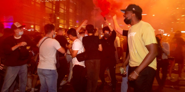 Montreal Canadiens fans celebrate on Rue Rene Levesque after the Montreal Canadiens defeated the Vegas Golden Knights in overtime in Game 6 of an NHL hockey Stanley Cup semifinal playoff series Thursday, June 24, 2021 in Montreal. (Peter McCabe/The Canadian Press via AP)