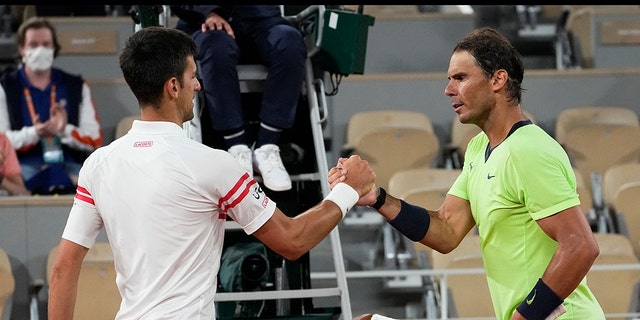 Serbia's Novak Djokovic, left, shakes hands with Spain's Rafael Nadal after their semifinal match of the French Open tennis tournament at the Roland Garros stadium Friday, June 11, 2021 in Paris. Novak Djokovic won 3-6, 6-3, 7-6 (4), 6-2. (AP Photo/Michel Euler)