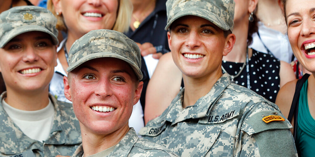FILE: Army 1st Lt. Shaye Haver, center, and Capt. Kristen Griest, right, pose for photos with other female West Point alumni after an Army Ranger school graduation ceremony at Fort Benning, Ga. Haver and Griest became the first female graduates of the Army's rigorous Ranger School.