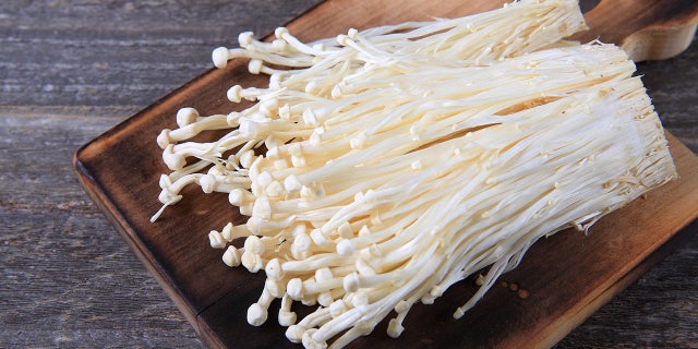 Fresh enoki mushrooms are shown here.