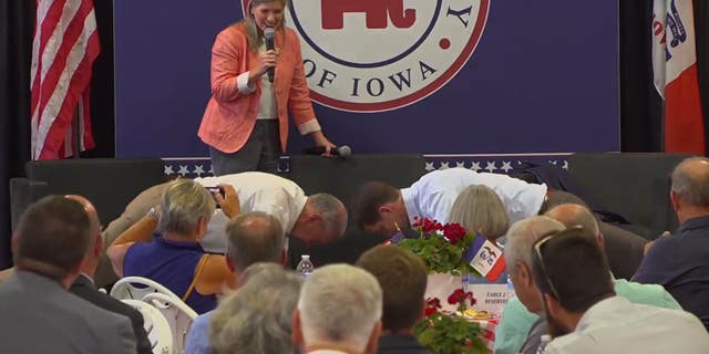 Sens. Chuck Grassley R-Iowa., and Tom Cotton R-Ark., do 22 push-ups at an event Tuesday in Iowa, while the state's other Republican senator, Joni Ernst, 50, counts them off