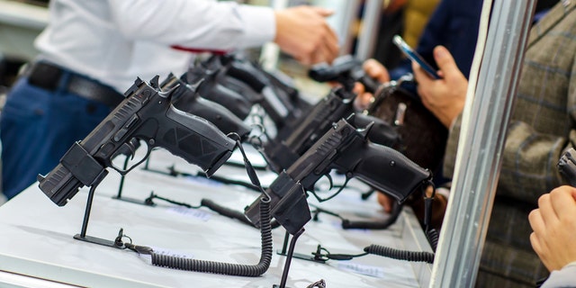 A photo of various handguns on display.