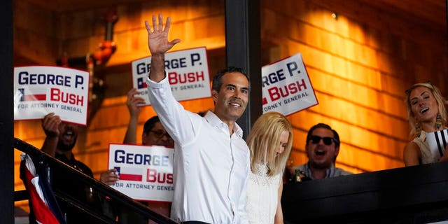 Texas Land Commissioner George P. Bush arrives for a kickoff rally with his wife, Amanda, to announce he will run for Texas attorney general, Wednesday, June 2, 2021, in Austin, Texas. (AP Photo/Eric Gay)