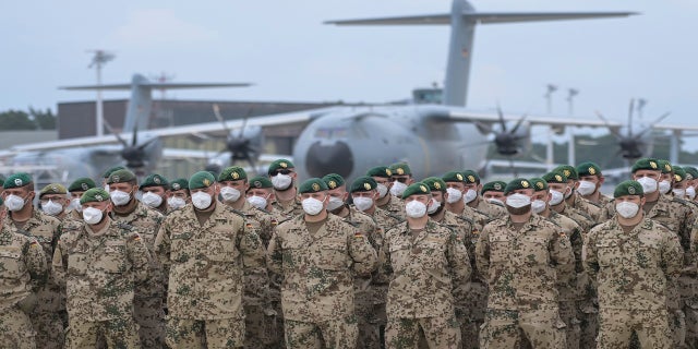 Soldiers from the German armed forces lined up in front of the German Air Force's Airbus A400M transport plane for the final roll call in Wunstorf, Germany, on Wednesday. The last soldiers from the German mission in Afghanistan have arrived at the Lower Saxony air base. (PA)