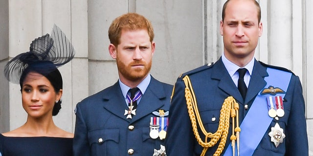 Meghan, Duchess of Sussex, Prince Harry, Duke of Sussex, Prince William, Duke of Cambridge and Catherine, Duchess of Cambridge stand on the balcony of Buckingham Palace to view a flypast to mark the centenary of the Royal Air Force (RAF) on July 10, 2018, in London, England.