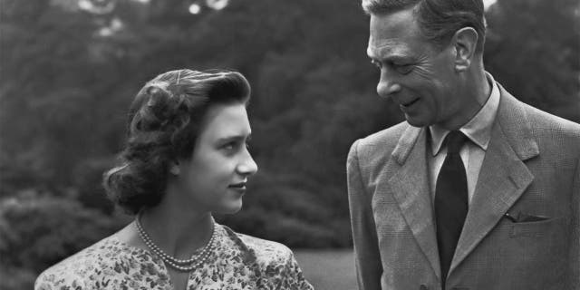 Princess Margaret (1930 - 2002) with her father King George VI (1895-1952) on the grounds of Windsor Castle in Windsor, England on July 8, 1946.