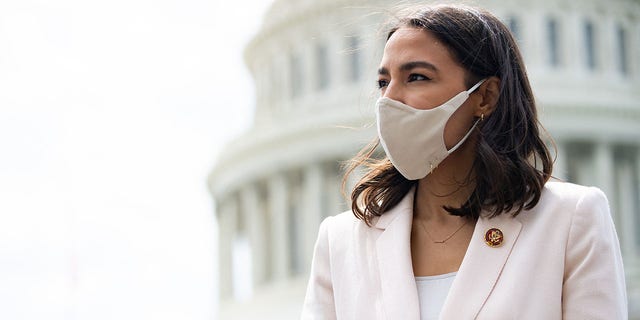 Rep. Alexandria Ocasio-Cortez attends a press conference about a postal banking pilot program outside the Capitol in Washington, on April 15, 2021. (Saul Loeb/ AFP via Getty Images)