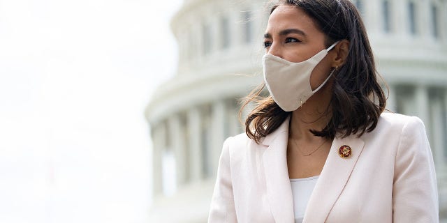 Rep. Alexandria Ocasio-Cortez attends a press conference about a postal banking pilot program outside the Capitol in Washington, on April 15, 2021. (Saul Loeb/ AFP via Getty Images)