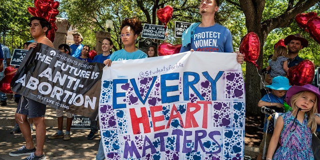 Pro-life protesters stand near the gate of the Texas state capitol at a protest outside the Texas state capitol on May 29, 2021, in Austin, Texas.