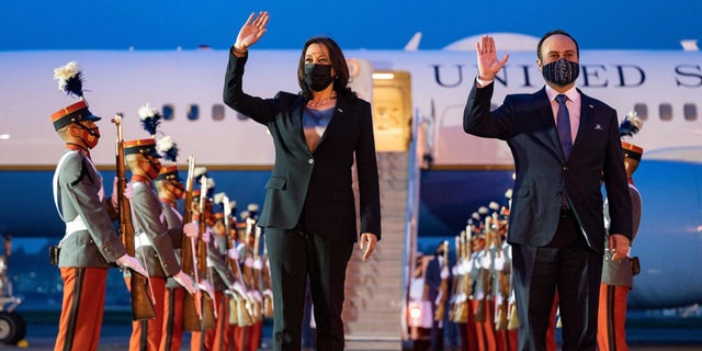 US Vice President Kamala Harris waves alongside Guatemalan Foreign Minister Pedro Brolo upon arrival in Guatemala City on June 6, 2021. 