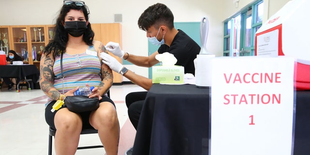 Wendy Ibarra prepares to receive her second COVID-19 vaccination dose at a vaccination clinic in South Los Angeles on June 25, 2021, in Los Angeles, California. (Photo by Mario Tama/Getty Images)