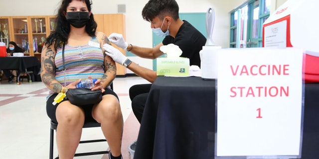 Wendy Ibarra prepares to receive her second COVID-19 vaccination dose at a vaccination clinic in South Los Angeles on June 25, 2021, in Los Angeles, California. (Photo by Mario Tama/Getty Images)