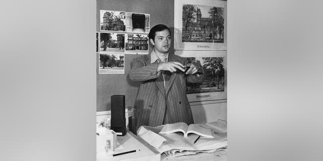 American actor, writer, director and producer Orson Welles (1915 - 1985) with production artwork for his film 'The Magnificent Ambersons', circa 1942.