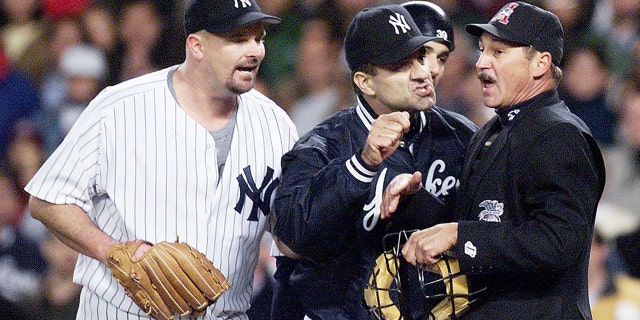 New York Yankee manager Joe Torre and pitcher David Wells argue with home plate umpire Jim Evans during the seventh inning of an American League Championship Series game at Yankee Stadium in New York. (DON EMMERT/AFP via Getty Images)