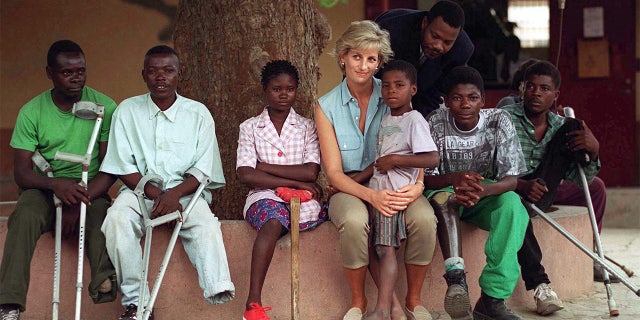 Diana, Princess of Wales, with children injured by mines at the Neves Bendinha Orthopaedic Workshop In Luanda, Angola.