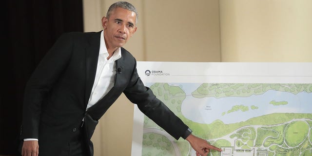 Former President Barack Obama points to features of the proposed Obama Presidential Center