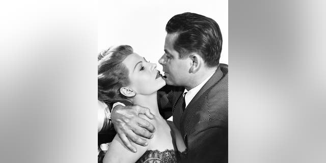 American actress Rita Hayworth (born Margarita Cansino, 1918 - 1987) (as Gilda Farrell) and Canadian-American actor Glenn Ford (1916 - 2006) (as Johnny Farrell/Narrator) in 'Gilda' (directed by Charles Vidor), Hollywood, California, 1946.