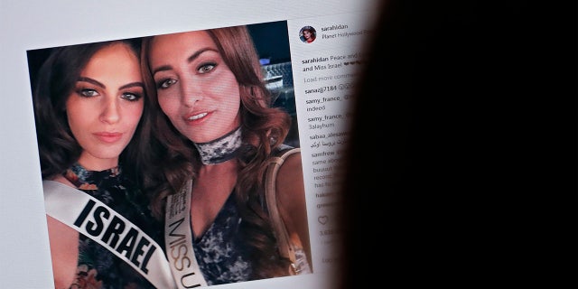 A picture taken on November 21, 2017 shows a picture posted by the Instagram profile of Sarah Idan on November 14, who holds the titles of "Miss Iraq USA 2016" and "Miss Iraq Universe 2017", as she is seen taking a "selfie" photograph with Adar Gandelsman, who holds the title of "Miss Universe Israel 2017", with a caption reading: "Peace and Love from Miss Iraq and Miss Israel #missuniverse".