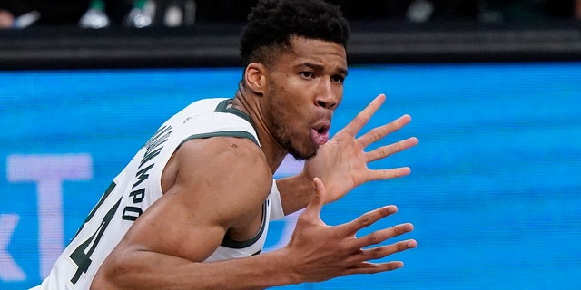 Milwaukee Bucks striker Giannis Antetokounmpo (34) reacts after dunking alongside Brooklyn Nets striker Blake Griffin (2) during the first half of Game 5 of a second round of the NBA basketball playoff series on Tuesday, June 15, 2021 in New York.