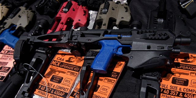 A MCK pistol brace for a handgun is displayed with firearm accessories for sale at the Crossroads of the West Gun Show at the Orange County Fairgrounds on June 5, 2021 in Costa Mesa, California.