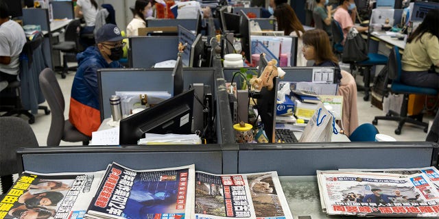 Reporters work at the news room of Apple Daily Monday, April 26, 2021, in Hong Kong.