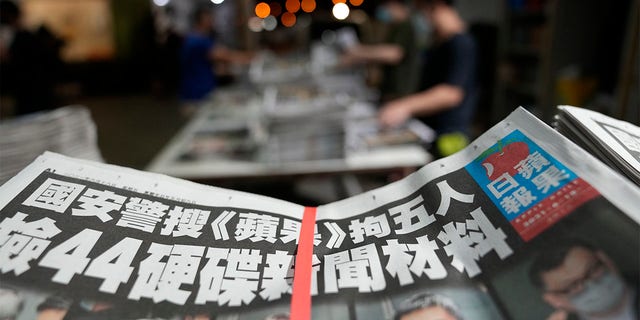 Copies of Apple Daily newspaper are packed at the printing house in Hong Kong, early Friday, June 18, 2021. (AP Photo/Kin Cheung)