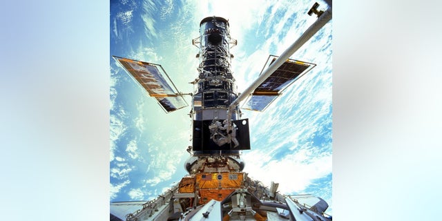 Astronauts Steven L. Smith and John M. Grunsfeld during an extravehicular activity (EVA) during the December 1999 Hubble servicing mission of STS-103, flown by Discovery. (Associated Press)