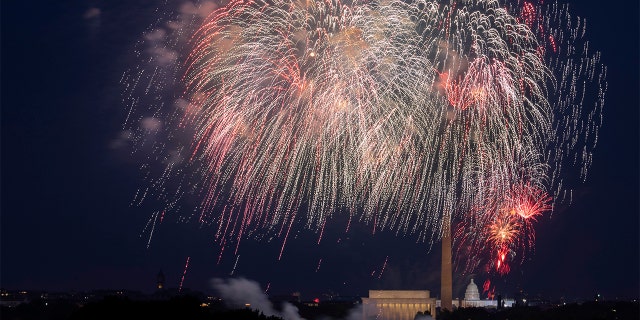 FILE - In this Saturday, July 4, 2020, file photo, Fourth of July fireworks explode over the Lincoln Memorial, the Washington Monument and the U.S. Capitol along the National Mall in Washington. (AP Photo/Cliff Owen, File)