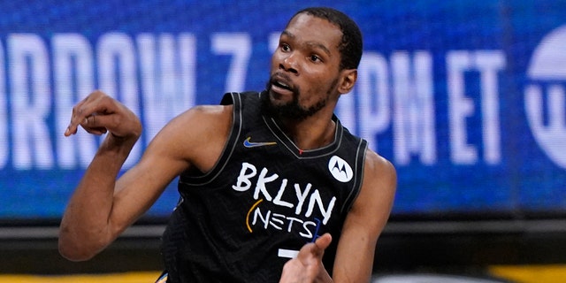 Brooklyn Nets forward Kevin Durant watches as he sinks a three-point shot during the fourth quarter of Game 5 of a second-round NBA basketball playoff series against the Milwaukee Bucks, Tuesday, June 15, 2021, in New York.