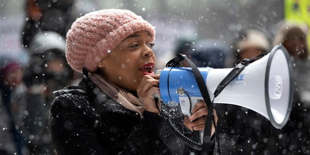 Kina Collins, a board member of the Illinois chapter of the Women's March, speaks as protestors gather in Federal Plaza for the Third Annual Women's March on Saturday, Jan. 19, 2019, in Chicago.