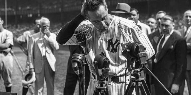 Lou Gehrig #4 of the New York Yankees is shown before the mic delivering his farewell speech on Lou Gehrig Day on July 4, 1939 at Yankee Stadium in the Bronx, New York.