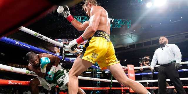 Floyd Mayweather, left, and Logan Paul fight during an exhibition boxing match at Hard Rock Stadium, June 6, 2021, in Miami Gardens, Florida. (AP Photo/Lynne Sladky)