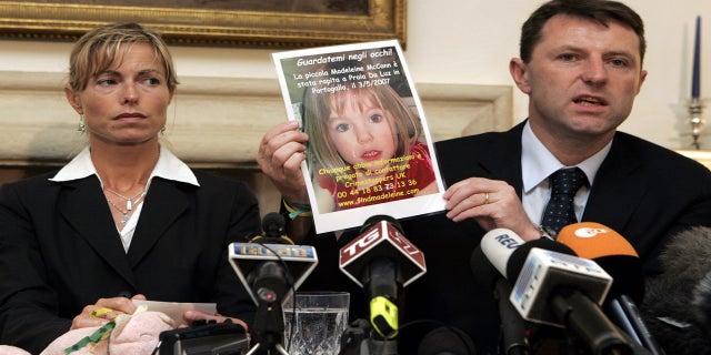 Kate McCann, left, looks on as her husband Gerry holds up a picture of their missing daughter Madeleine during a news conference in Rome, on May 30, 2007.