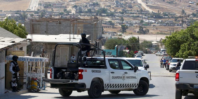 Members of the National Guard keep watch the a scene where unknown assailants left a plastic bag with human remains near a polling station, during the mid-term elections in Tijuana, Mexico June 6, 2021. REUTERS/Jorge Duenes