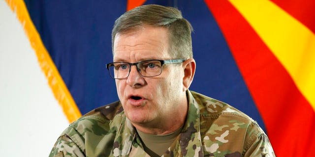 In this May 20, 2020, ファイル写真, then-Arizona National Guard Maj. 遺伝子. Michael McGuire, director of the Department of Emergency and Military Affairs, answers a question at a news conference in Phoenix. マクガイア, the former head of the Arizona National Guard, has filed papers to run for the U.S. 上院, joining what's likely to be a crowded field of candidates seeking the Republican nomination.