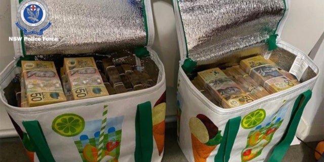 Bags of cash seized during a raid in Australia.