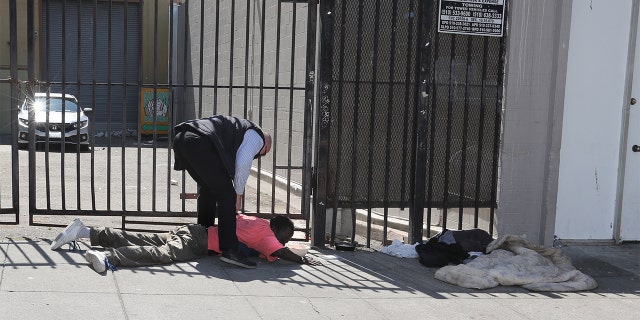 OAKLAND, CA - JUNE 17: One of Governor Newsom's security detail detains a man after he allegedly assaulted the California Governor during a visit to a small business in the seven hundred block of Washington Street in Oakland, Calif., on Thursday, June 17, 2021. "Members of the Governor"u2019s security detail removed the Governor from the situation and the individual was arrested by CHP officers,"u201d the CHP, which provides security for the governor, said in a statement. (Photo by Ray Chavez/MediaNews Group/East Bay Times via Getty Images)