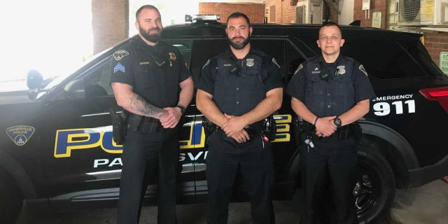 Sgt Matthew Tycast, left, and Officers Daniel Thompson and Chad Balausky were hailed as heroes for their efforts to save the unresponsive child.