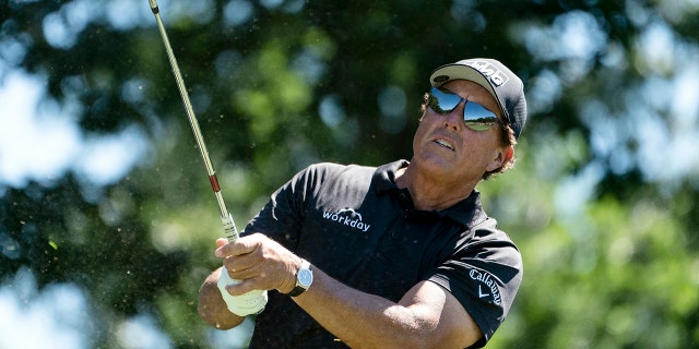 Phil Mickelson watches his shot off the 11th tee during the first round of the Travelers Championship golf tournament at TPC River Highlands, Thursday, June 24, 2021, in Cromwell, Conn.