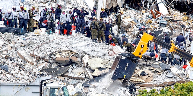 Emergency workers at the site of a partially collapsed residential building in Surfside, near Miami Beach, Florida, June 29, 2021. (Reuters/Joe Skipper)