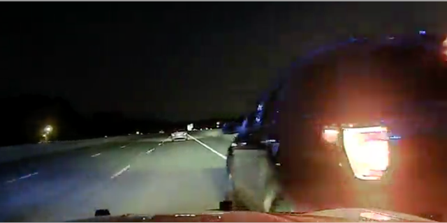 This still image from Officer Rodney Dunn's dashcam shows Nicole Harper with her emergency blinkers on just seconds before the PIT maneuver was performed that flipped her car.