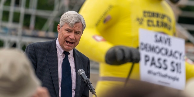 Sen. Sheldon Whitehouse, D-R.I., speaks at a rally in front of the Supreme Court in Washington, Wednesday, June 9, 2021, to support the Senate's upcoming election bill. (AP Photo/Andrew Harnik)