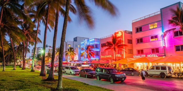 Pedestrians and traffic pass through Ocean Drive. The road is the main thoroughfare through South Beach and is known for distinctive art deco architecture.