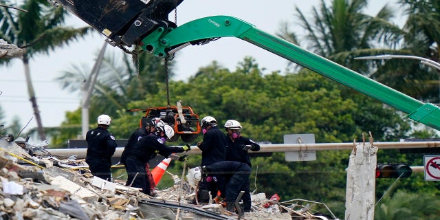 Crews work in the rubble of Champlain Towers South residential condo on Tuesday. (AP)