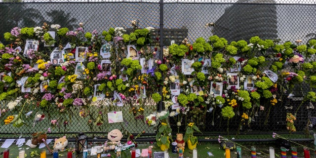 A makeshift memorial is set up near the site of the collapsed condominium in Surfside, Fla., on Monday. (AP/Miami Herald)