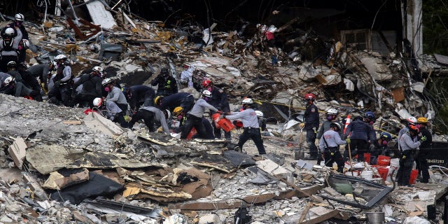 Search and rescue teams look for survivors at the Champlain Towers South residential condo on Tuesday. (AP/Miami Herald)