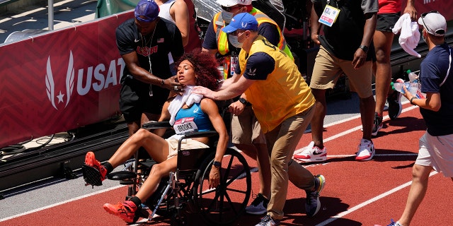 Taliyah Brooks was rescued after falling during a heptathlon at the U.S. Olympic track and field test. On Sunday, June 27, 2021, in Eugene, Ore., activities were suspended due to high temperatures. (AP Photo/Charlie Reedel)