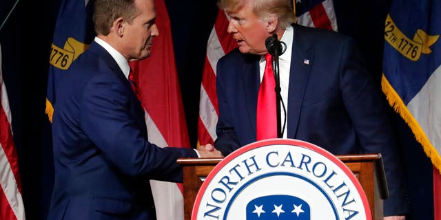 Former President Donald Trump, right, announces his endorsement of N.C. Rep. Ted Budd, left, for the 2022 North Carolina U.S. Senate seat as he speaks at the North Carolina Republican Convention Saturday, June 5, 2021, in Greenville, N.C. (AP Photo/Chris Seward)