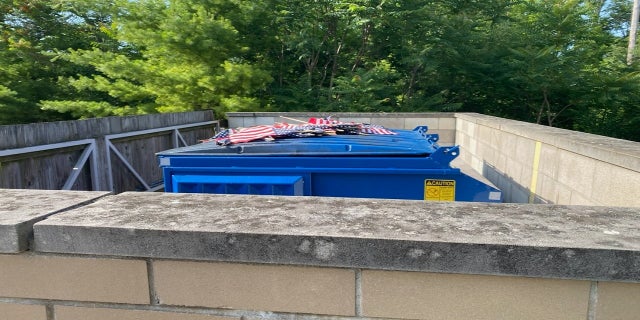 Other flags from the display, which is set to remain through the Fourth of July holiday, were placed on top of a dumpster near the facility. (Courtesy VFW Post & Auxiliary #1138)