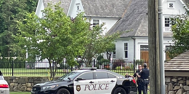 Westport, Connecticut, police officers are seen Friday outside a home where a mother and daughter were found dead Thursday. (Connor Ryan/Fox News)